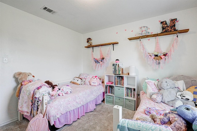 carpeted bedroom featuring visible vents