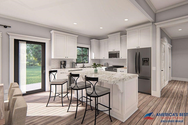 kitchen featuring a sink, stainless steel appliances, white cabinets, and crown molding