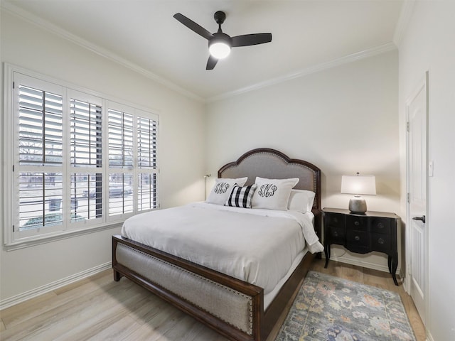 bedroom featuring crown molding, light wood-style floors, and baseboards