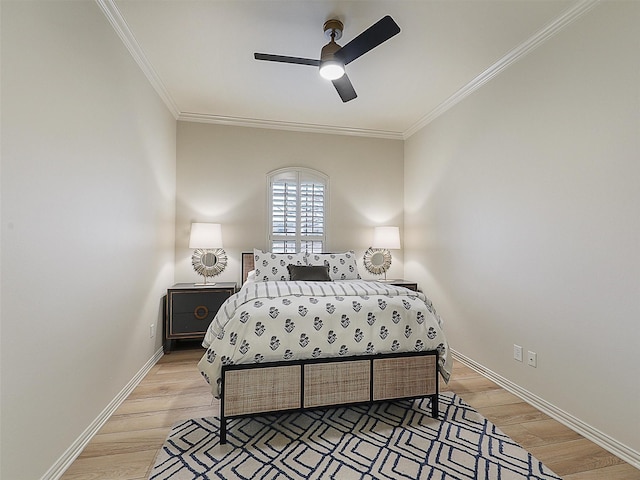 bedroom featuring baseboards, light wood-type flooring, and ornamental molding