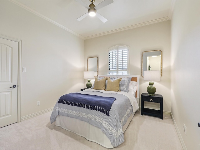 carpeted bedroom featuring ceiling fan, baseboards, and ornamental molding