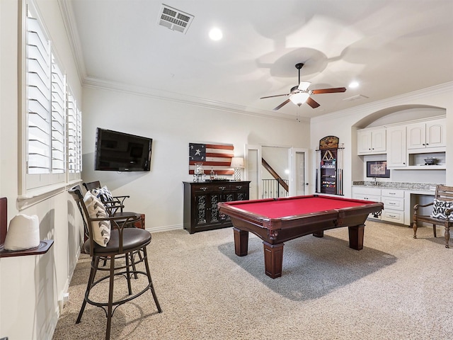 rec room featuring ceiling fan, crown molding, visible vents, and light carpet