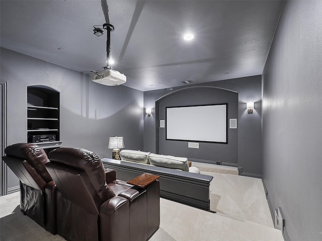 home theater room featuring built in features and carpet flooring