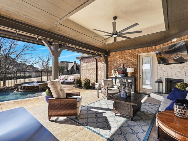 view of patio / terrace featuring ceiling fan, an outdoor hangout area, a fenced backyard, and a pool with connected hot tub