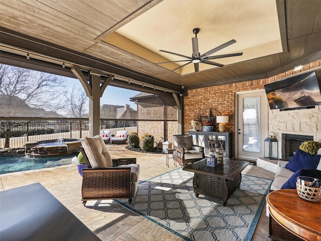 view of patio with outdoor lounge area, a fenced backyard, a pool with connected hot tub, and ceiling fan