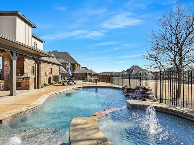 view of pool with a pool with connected hot tub, a patio, central AC, a fenced backyard, and exterior kitchen