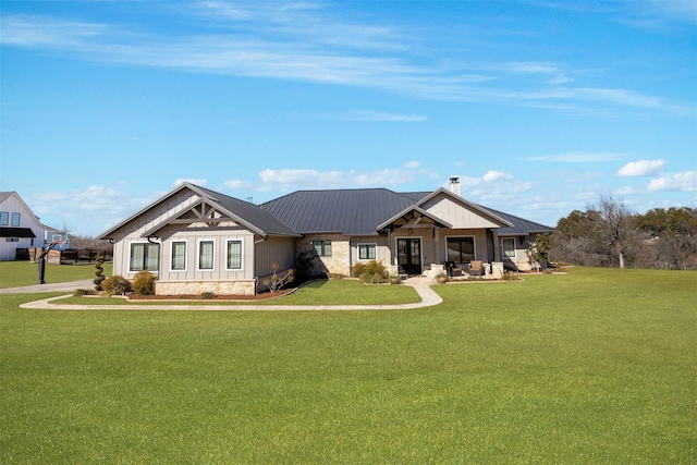 craftsman inspired home with a front yard, board and batten siding, and metal roof