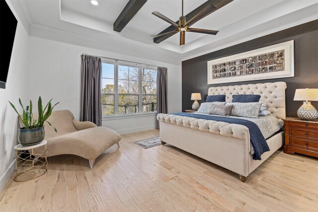 bedroom with a raised ceiling, light wood-style flooring, a ceiling fan, recessed lighting, and baseboards