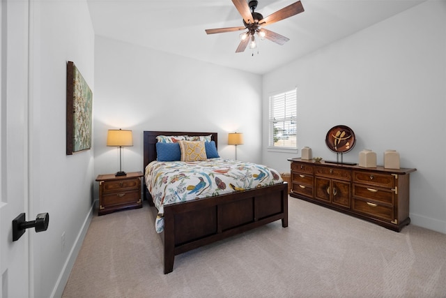 bedroom with light carpet, ceiling fan, and baseboards