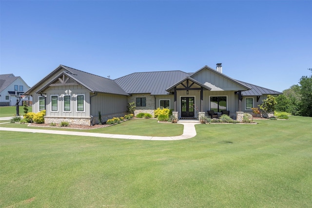 craftsman-style home featuring a standing seam roof, a chimney, metal roof, and a front lawn