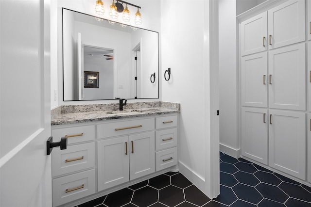 bathroom featuring vanity, tile patterned floors, and baseboards