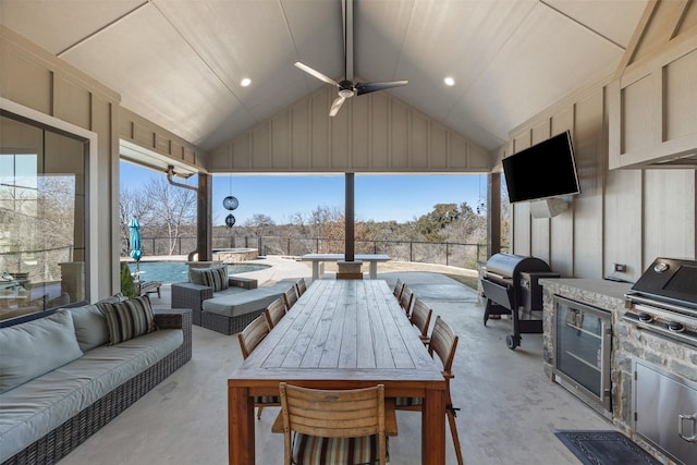 view of patio / terrace featuring an outdoor living space, grilling area, exterior kitchen, and ceiling fan