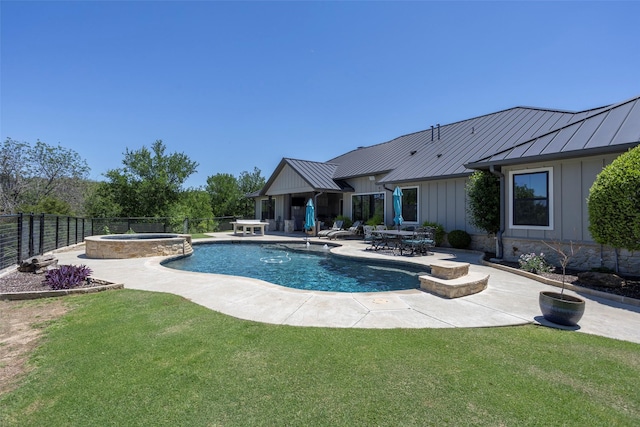 view of pool with a fenced backyard, a patio area, a pool with connected hot tub, and a yard