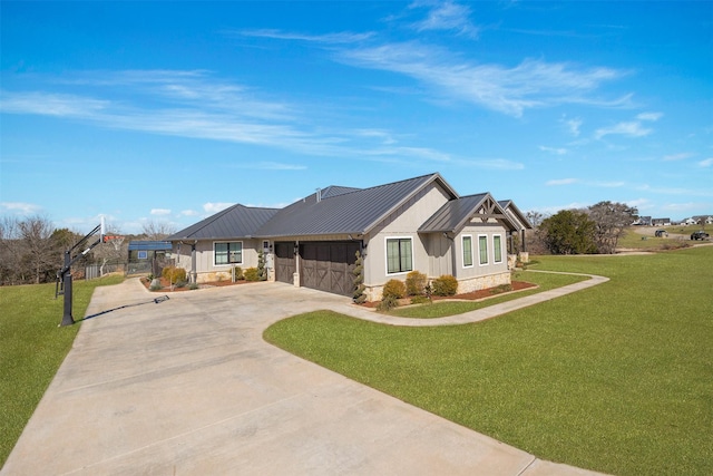 view of front of house with a garage, metal roof, a front lawn, and a standing seam roof