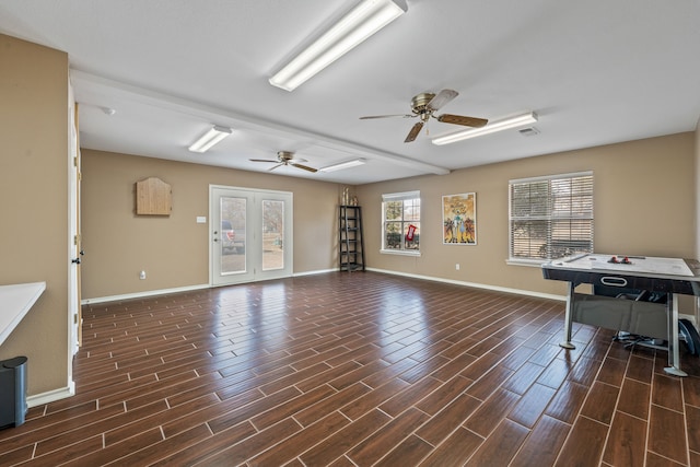 unfurnished living room featuring visible vents, baseboards, ceiling fan, and wood tiled floor