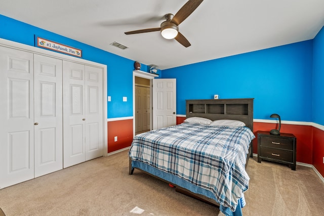 bedroom featuring a closet, baseboards, a ceiling fan, and carpet flooring