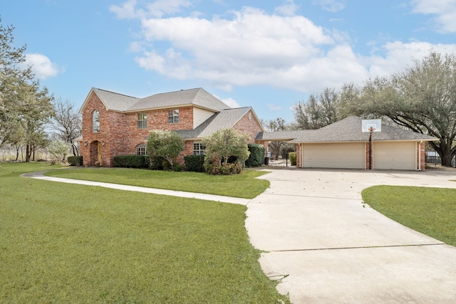 traditional-style home with brick siding, a garage, concrete driveway, and a front lawn