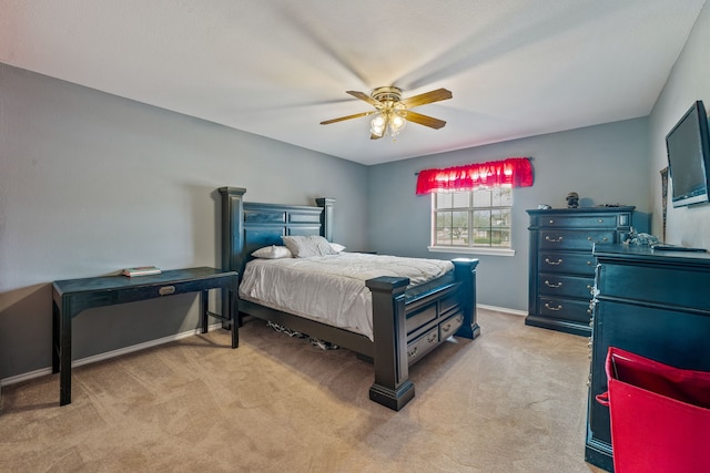 bedroom featuring light colored carpet, baseboards, and ceiling fan