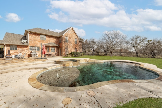 exterior space featuring a patio area, a pool with connected hot tub, a yard, and fence