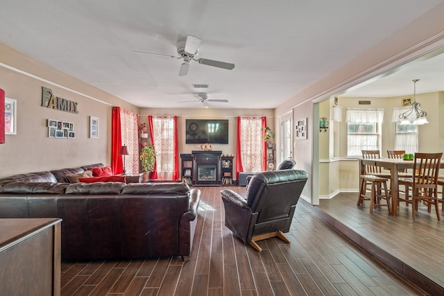 living room featuring a wealth of natural light, visible vents, a ceiling fan, and wood finish floors