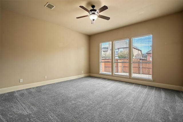 spare room featuring visible vents, ceiling fan, baseboards, and carpet floors