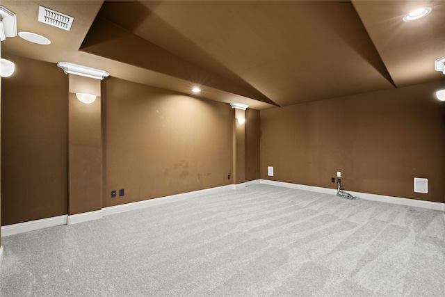 basement with visible vents, baseboards, and carpet flooring