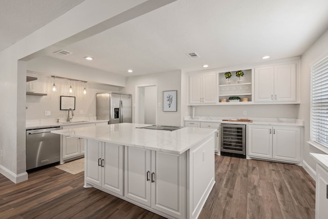 kitchen with visible vents, open shelves, wine cooler, stainless steel appliances, and a sink