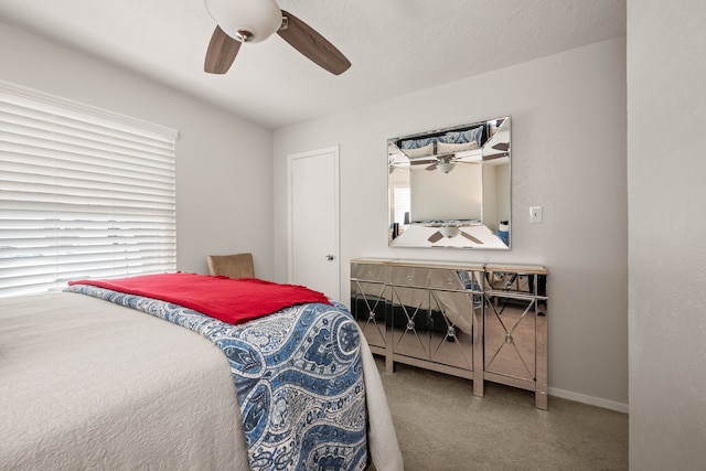 bedroom featuring baseboards, carpet floors, and a ceiling fan