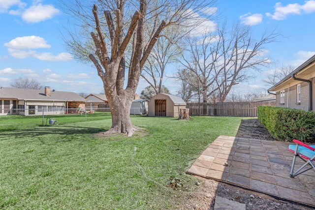 view of yard with a patio, a storage shed, a fenced backyard, and an outdoor structure