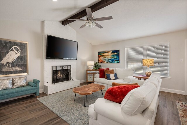 living room with ceiling fan with notable chandelier, lofted ceiling with beams, wood finished floors, and a fireplace