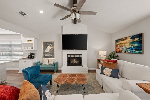 living area featuring visible vents, vaulted ceiling with beams, dark wood-type flooring, baseboards, and beverage cooler