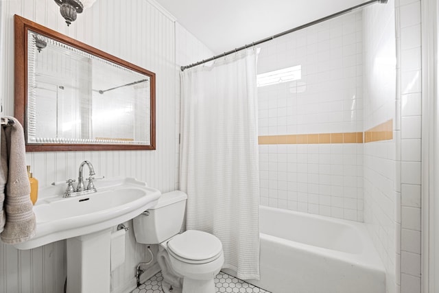 full bath with tile patterned floors, toilet, a sink, and shower / bath combination with curtain