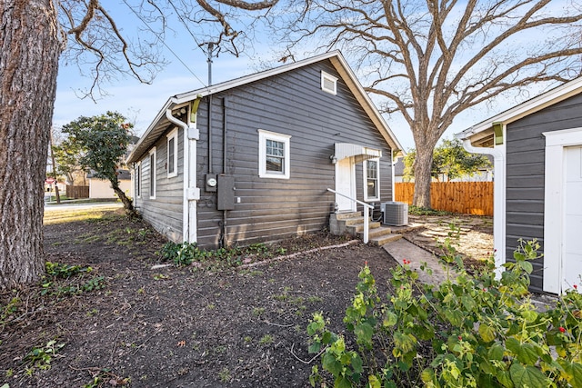 back of house with fence, central AC unit, and entry steps