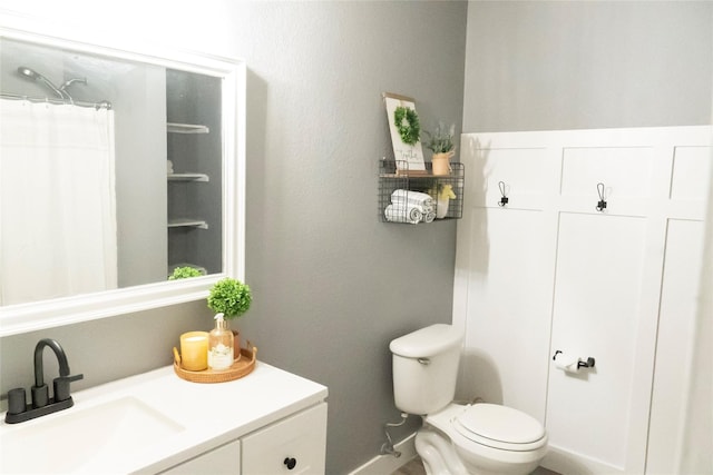 bathroom featuring curtained shower, toilet, and vanity