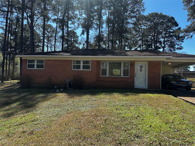 ranch-style home featuring driveway, a front lawn, an attached carport, and brick siding