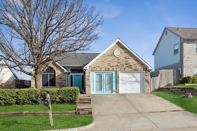 view of front of property featuring brick siding, a front lawn, fence, a garage, and driveway