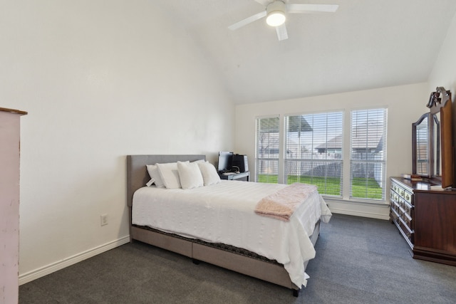 bedroom featuring lofted ceiling, baseboards, dark carpet, and ceiling fan