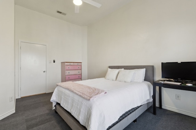 bedroom featuring dark colored carpet, visible vents, baseboards, and a ceiling fan