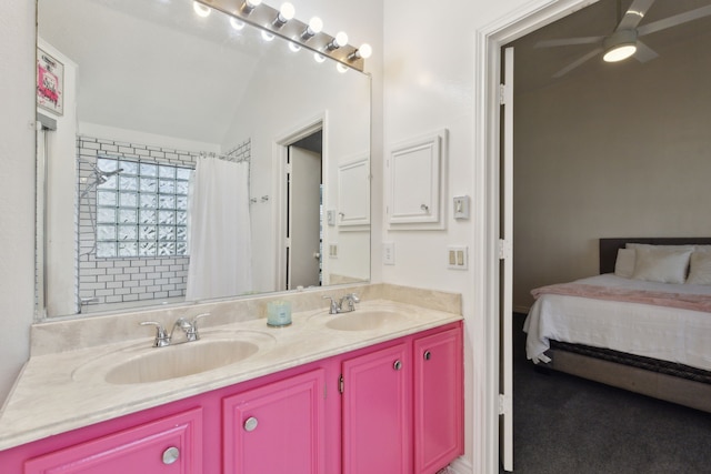 bathroom with a shower with shower curtain, double vanity, a ceiling fan, and a sink