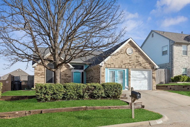 view of front of house featuring brick siding, an attached garage, concrete driveway, and a front yard