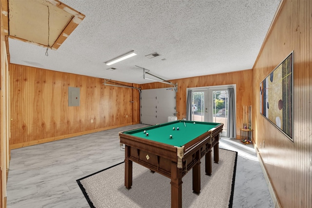 playroom with wood walls, billiards, electric panel, and attic access
