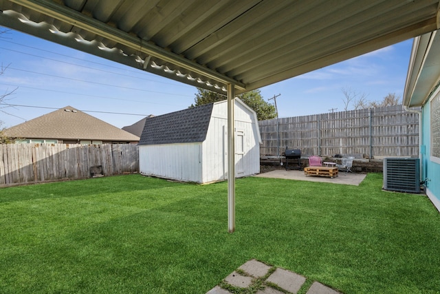 view of yard featuring central AC, a fenced backyard, a patio area, and a shed