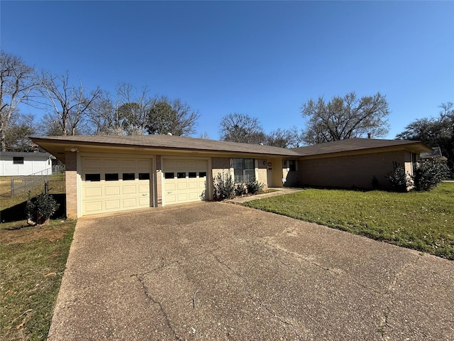 view of front of property with driveway, an attached garage, a front yard, and fence