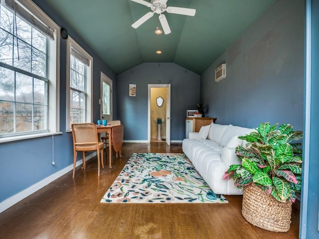 interior space with lofted ceiling, wood finished floors, baseboards, and ceiling fan