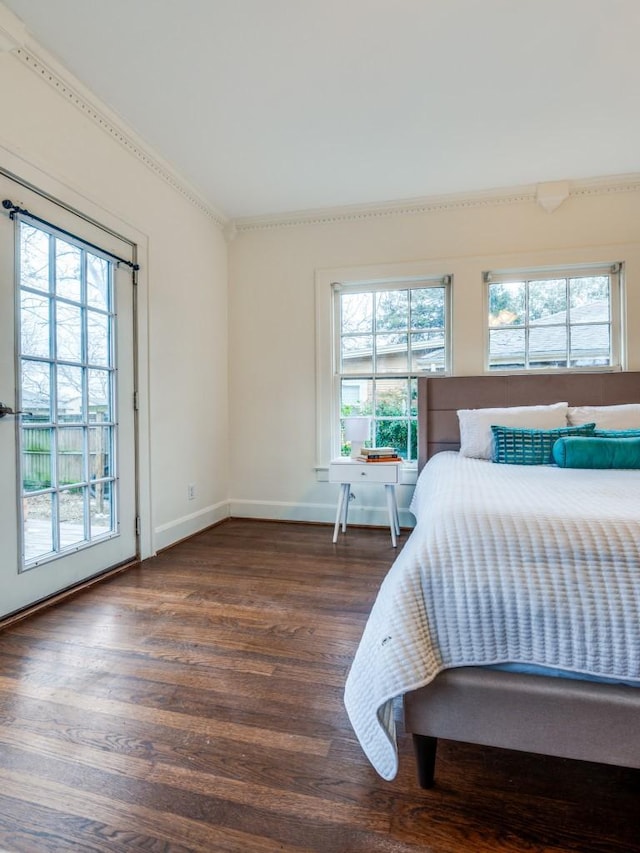 bedroom featuring wood finished floors and baseboards