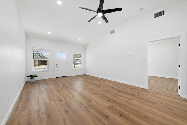 unfurnished living room featuring visible vents, recessed lighting, lofted ceiling, and light wood-style floors