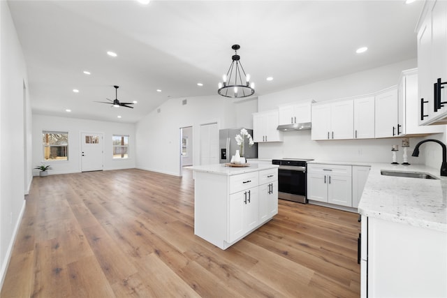 kitchen featuring a sink, stainless steel appliances, light wood-type flooring, and a kitchen island