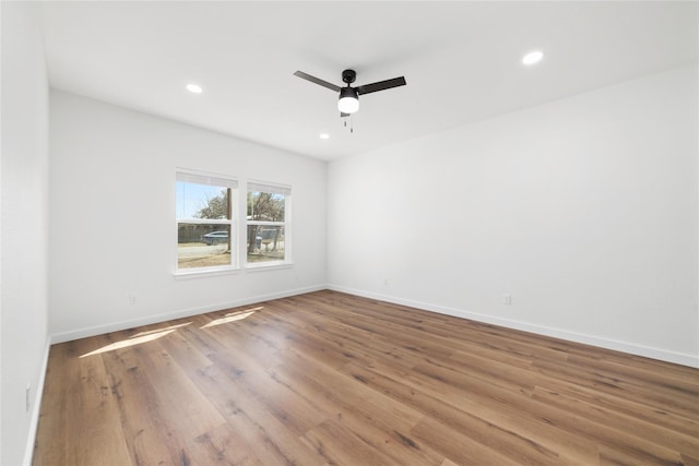 empty room featuring recessed lighting, baseboards, wood finished floors, and a ceiling fan