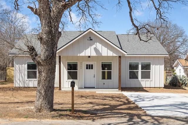 modern farmhouse style home with covered porch, board and batten siding, and a shingled roof