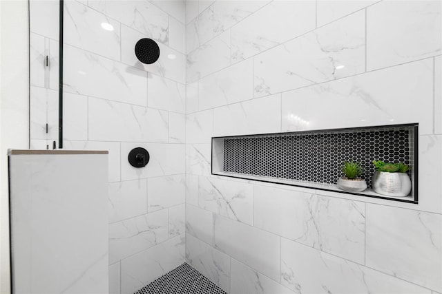 bathroom with tiled shower